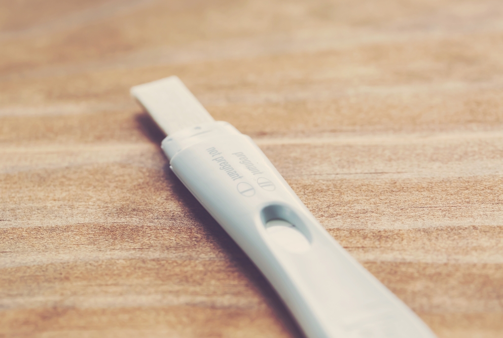 pregnancy test laying on a wooden surface