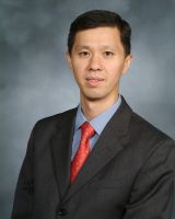 a man in a suit posing for a picture