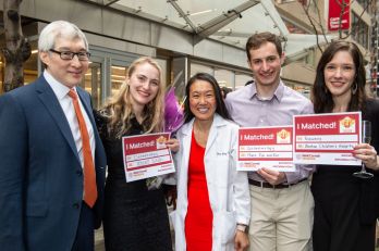 A group of students and medical professionals pose together for a photo during Match Day 2023