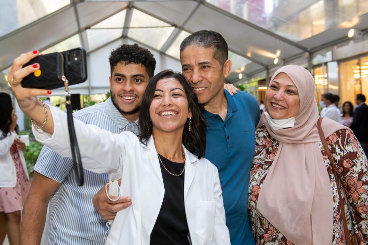 Rana Barghout captures the moment with her family after receiving her short white coat.