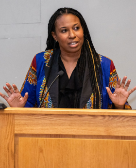 a woman talking at a podium