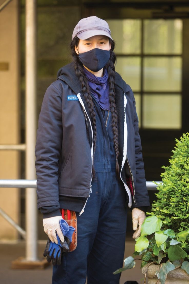 a person with pony tails posing for a photo in a face mask