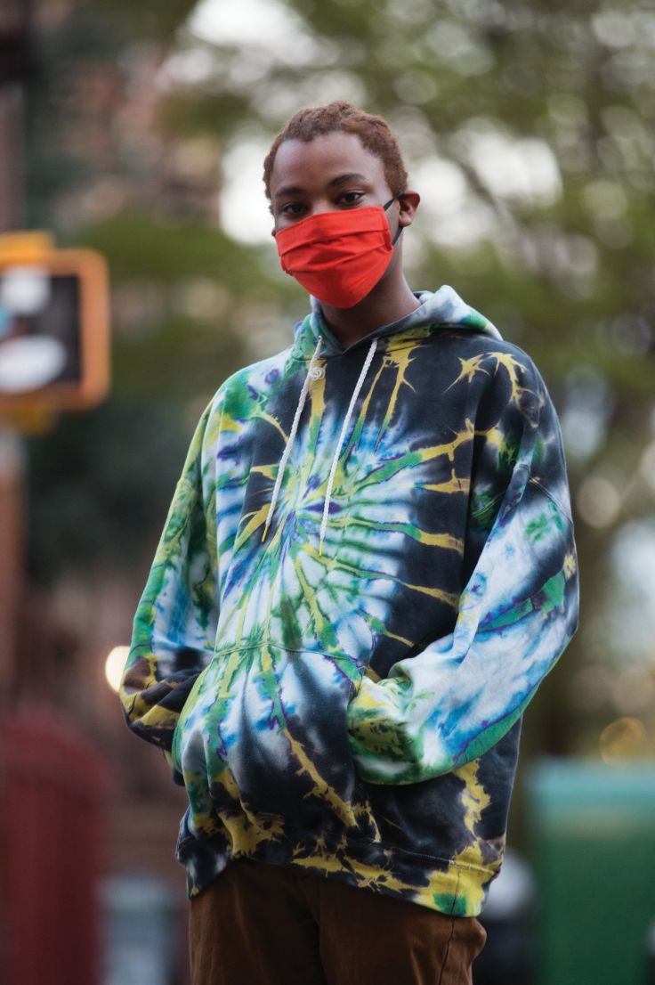 a boy wearing a red face mask