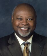 a man in a suit posing for a picture