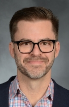 a man posing for a headshot photo
