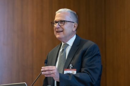 A man speaks at a podium