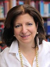 a woman in a white blouse posing for a headshot
