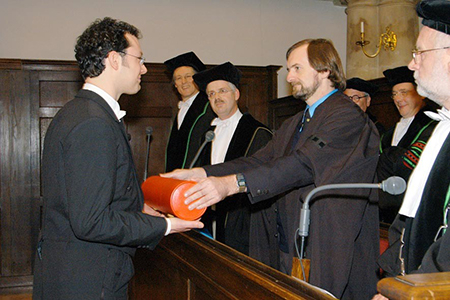man awarding doctorate to student