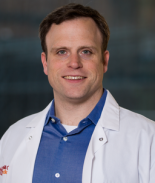 Dr. Christopher Mason A man smiling for a photo